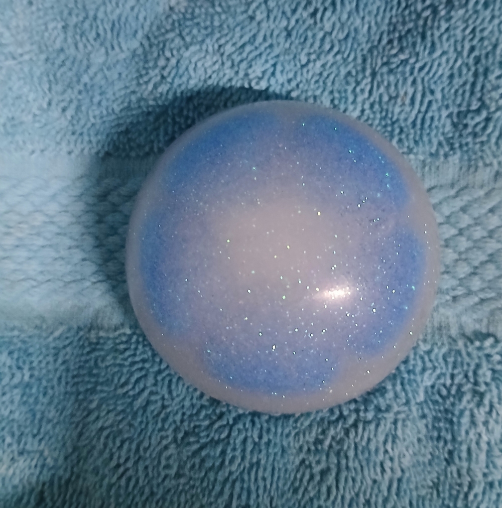 Blue and White Glittery Paperweight With Blue Flower Embedded Within